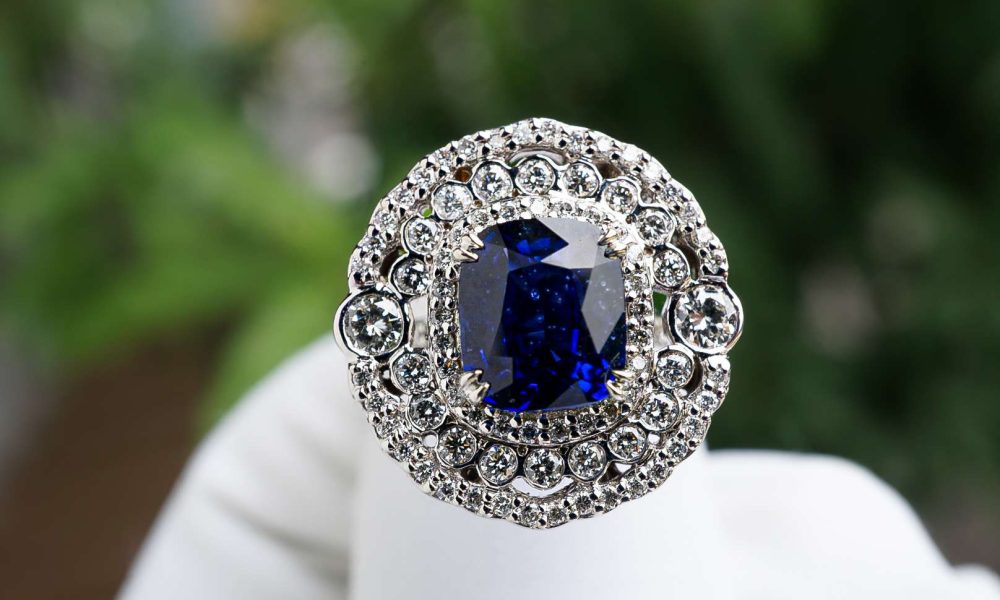 Diamond Carat - A Hand Holding an Elegant Cushion Cut Engagement Ring